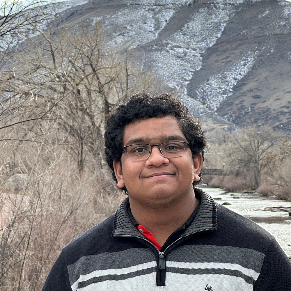 Student Taher Haji posing for a photo in front of Clear Creek